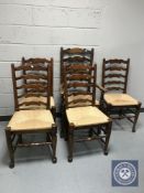 A set of five rush seated ladder backed kitchen chairs (one carver and four singles)