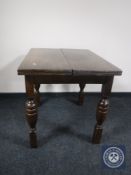 A 20th century oak pull out dining table
