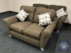 A three seater and two seater settees in brown fabric with loose cushions