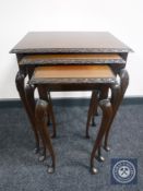 A nest of three mahogany tables on cabriole legs