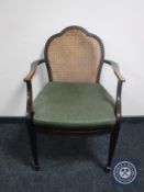 An antique mahogany bergere armchair