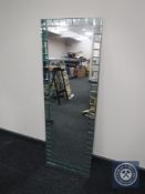 A contemporary all glass hall mirror