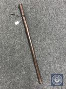 A turned wooden baton