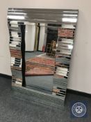 A contemporary all glass wave mirror 80 cm x 120 cm