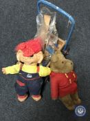 A Triang baby walker containing wooden toys,