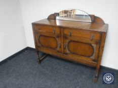 A 20th century oak mirror back sideboard