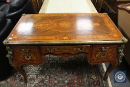 A reproduction ormolu mounted inlaid desk fitted with five drawers,