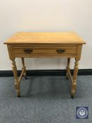 An Edwardian pine side table