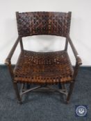 An armchair with leather sling seat