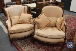 A pair of reproduction mahogany armchairs with scatter cushions