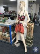 A female shop mannequin with leather and chain mail garment