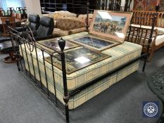 A 6' wrought iron bed framed with a Myers twin sprung storage divan and interior