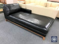 A contemporary black leather day bed