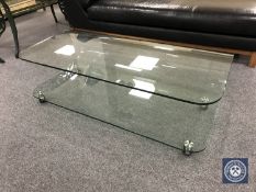 A contemporary curved glass two tier ghost coffee table