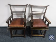 A pair of Chinese style armchairs with leather cushions