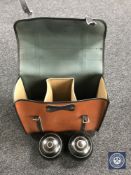 A leather lawn bowls bag containing a set of four bowls