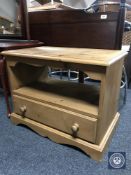A pine entertainment stand fitted a drawer