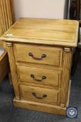 A pair of carved pine three drawer bedside chests,