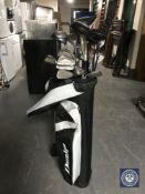 A Dunlop golf bag containing Pure Classic irons and assorted drivers