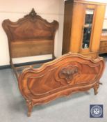 A carved walnut French bed frame
