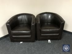 A pair of brown leather tub chairs