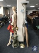 A brass floor lamp together with a glass topped occasional table on elephant base and a metal