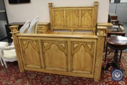 A carved pine kingsize bed frame,