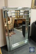 An all glass bevelled mirror,