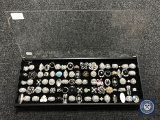 A display case containing approximately 85 costume rings