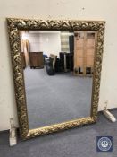 A decorative gilt framed overmantel mirror