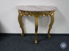 A marble topped demi lune hall table on gilt base