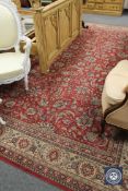 A machine made carpet of Kashan design, on red ground,