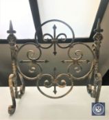 A wrought iron fire screen