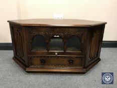 An oak linen fold corner TV stand