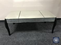 A contemporary mirrored coffee table