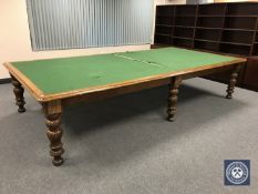 A Victorian oak boardroom table on turned legs fitted two drawers,