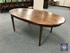 An oval hardwood dining table