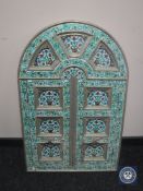 An arched topped double door window shutter