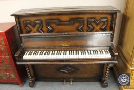 An oak cased piano by James Smith and Son of Liverpool
