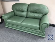 A green leather two seater bed settee