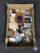 A box of militaria including cigarette cards, regimental plaques, badges,
