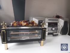 A Sony hifi system with speakers together with an electric fire with glass coals