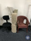 A basket chair, three contemporary rugs,