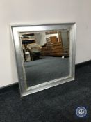 A square silvered framed mirror