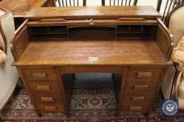 A mid 20th century oak roll top desk,