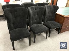 A set of six contemporary black buttoned dining chairs with lion mask handles