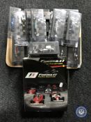 A tray containing fifteen Formula 1 Collection cars in display cases with magazines