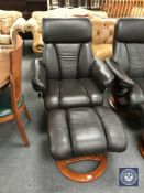 A brown leather swivel relaxer chair with stool