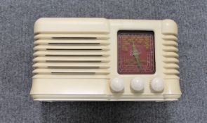 A Bartons Radio Limited cream cased radio.