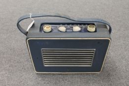 A vintage radio : Hacker Herald in blue case.